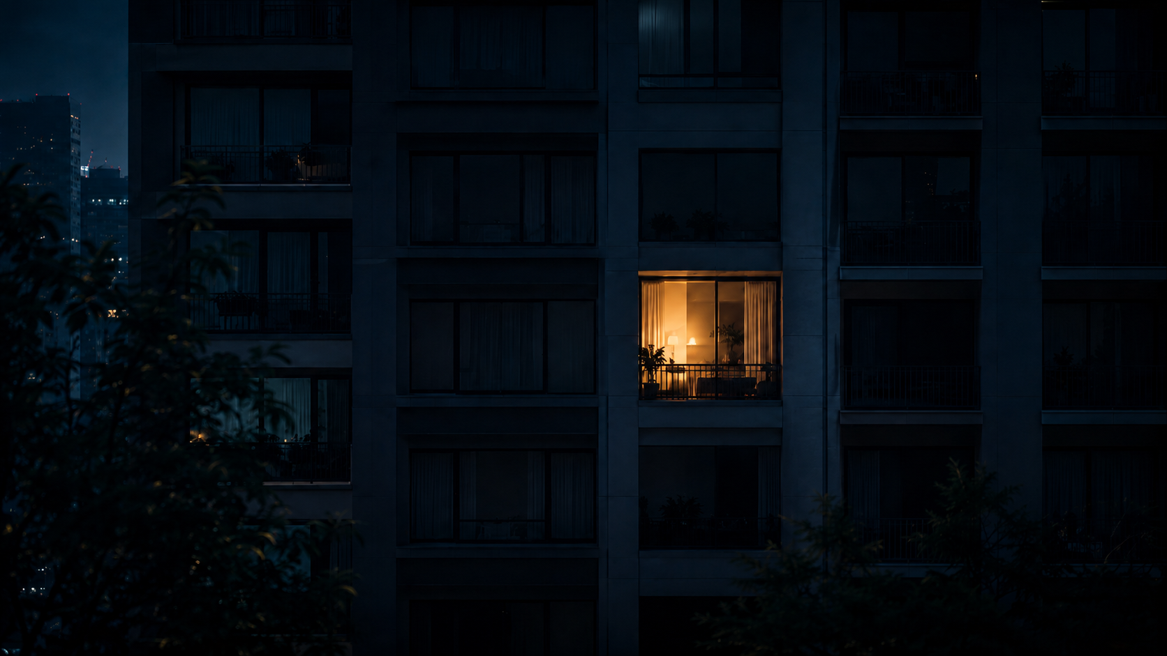 Conceptual illustration of a single lit window in a large dark apartment block, evoking a nation where living alone has become the most common way of life.